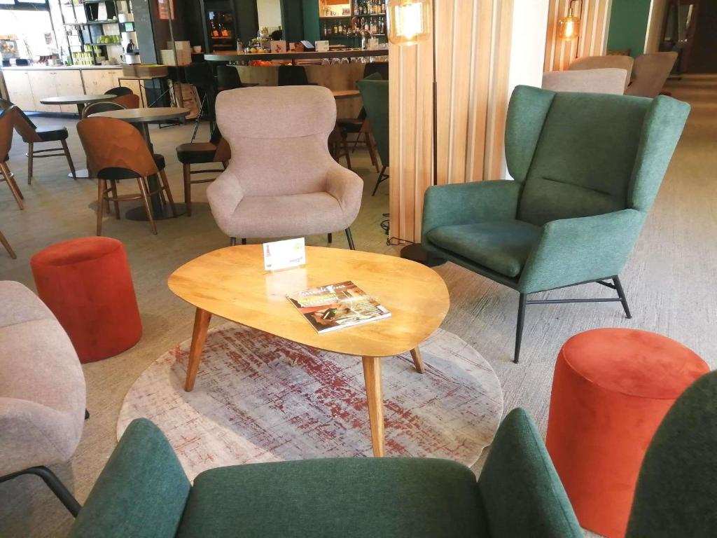 a room with chairs and a coffee table in a store at ibis Styles Tours Sud in Chambray-lès-Tours
