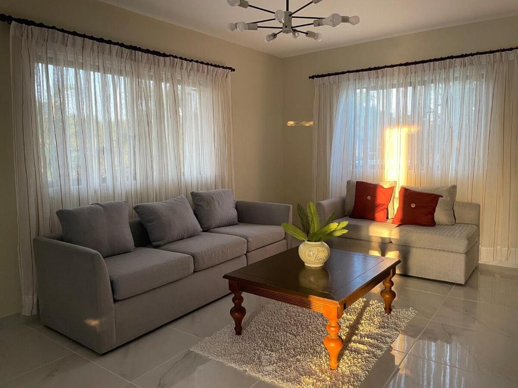 a living room with a couch and a coffee table at Jeda Village in Higuey