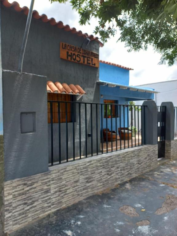 a building with a fence in front of it at La Casa de Doña Adela in Eugenio Bustos