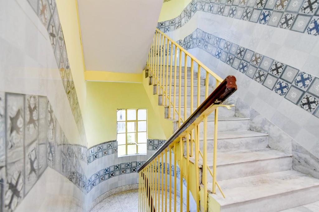 a staircase in a house with blue and white tiles at Super Hotel O Three Sixty Five Inn Guest House in Salt Lake City