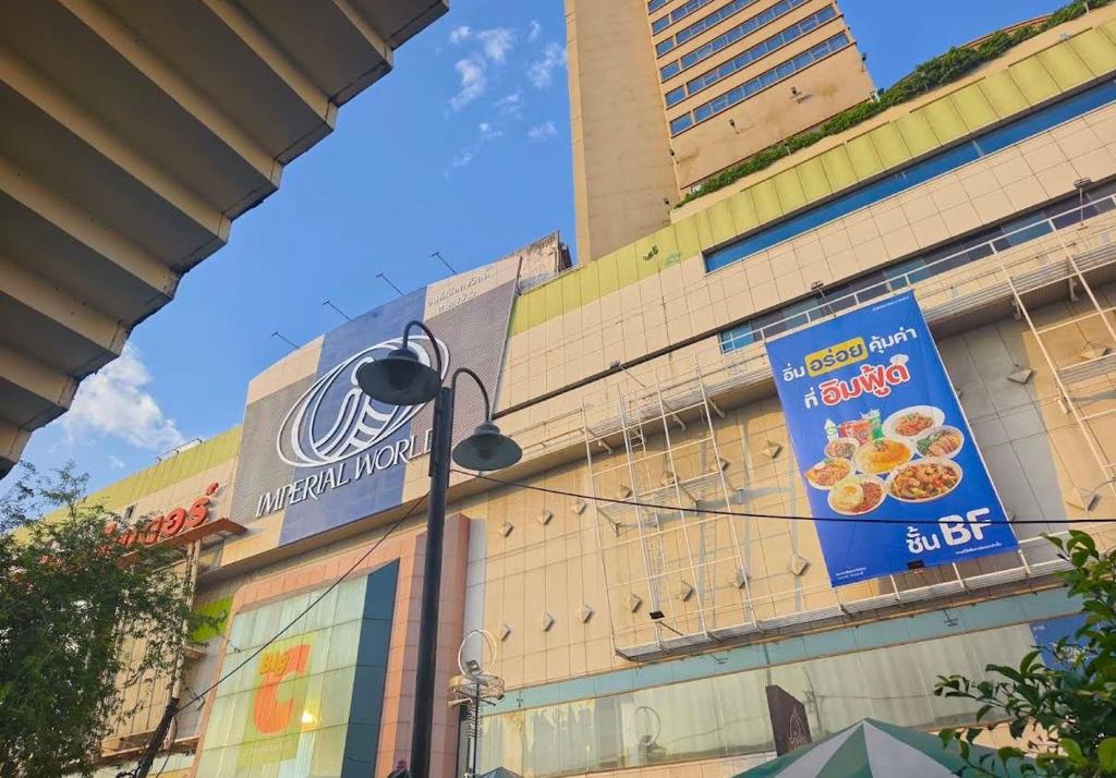 a building with a sign on the side of it at lee hotel lat phrao in Bangkok