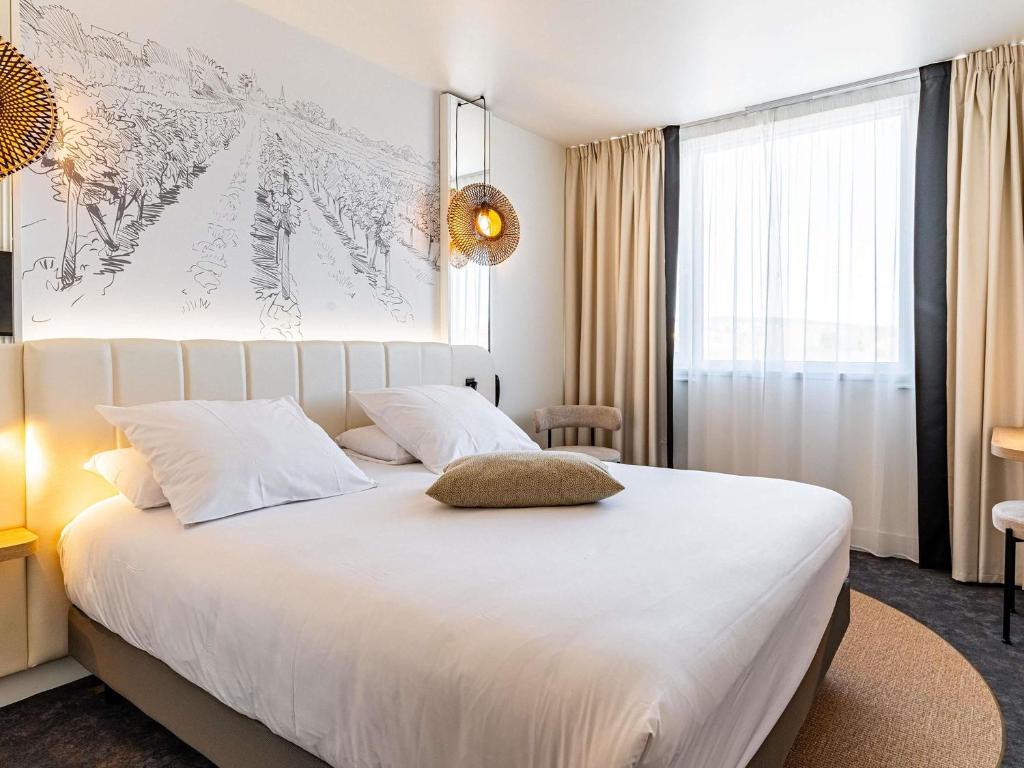 Voodi või voodid majutusasutuse Mercure Beaune Centre toas