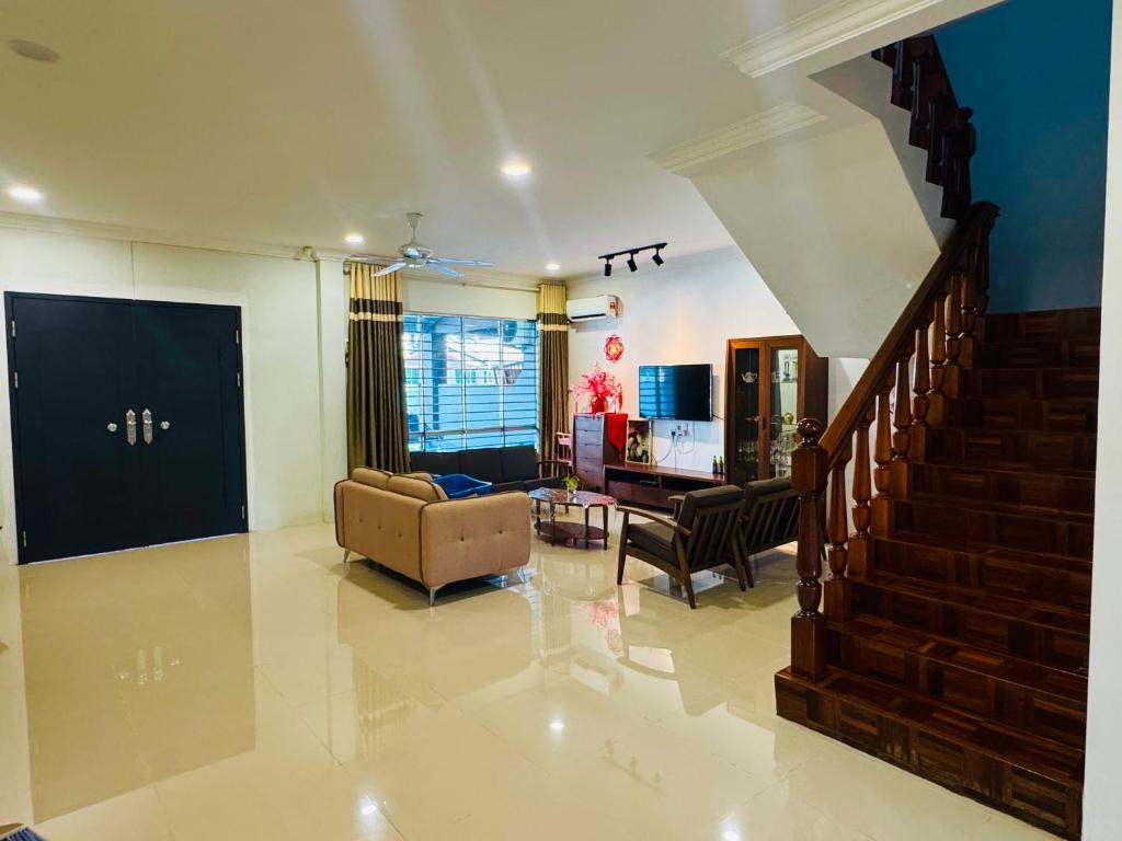 a living room with a couch and a stair case at HMHome-SIX in Gua Sai