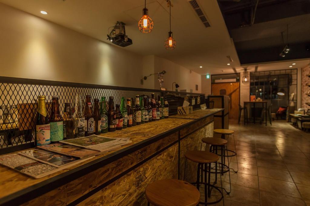 a bar with a bunch of bottles of alcohol at Mini Voyage Hostel in Hualien City