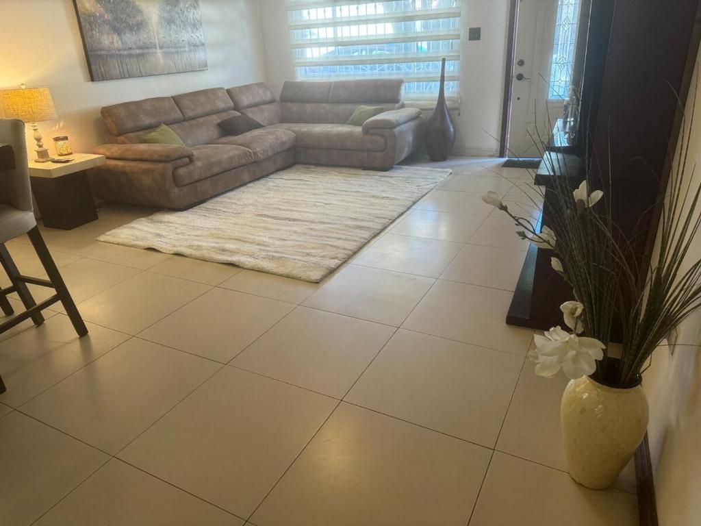 a living room with a couch and a table at Casa Futuro in San Lorenzo