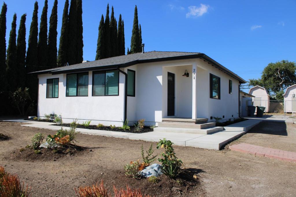 a small white house with trees in the background at Newly Renovated La Habra 3bed 2 Bath in La Habra