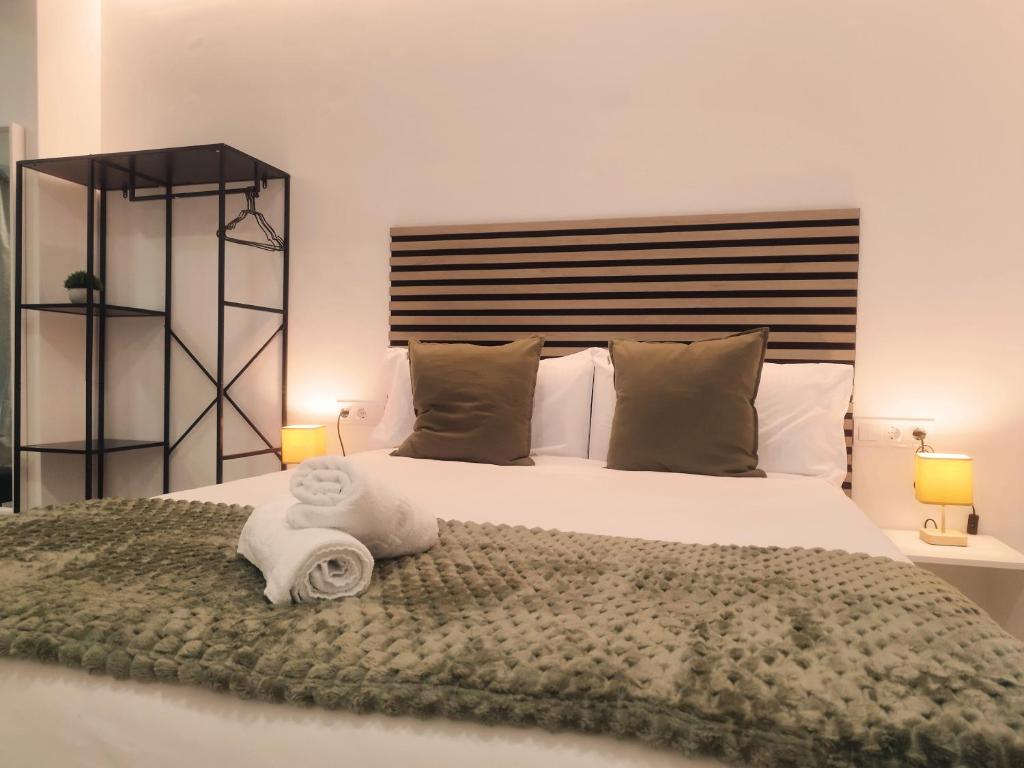 a bedroom with a large bed with two towels on it at GO&REST Apartments in Valencia