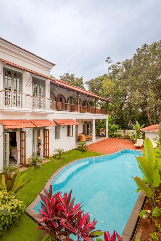 an external view of a house with a swimming pool at La Dona by The Blue Kite - 4BHK Private Pool Villa in Assagao with Garden, Balcony, Caretaker & Spacious Living Area in Assagao