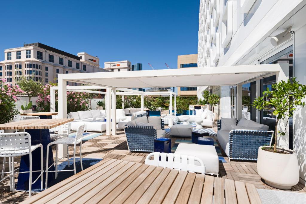 a patio with chairs and tables on a building at Golden Tulip Marseille Euromed in Marseille
