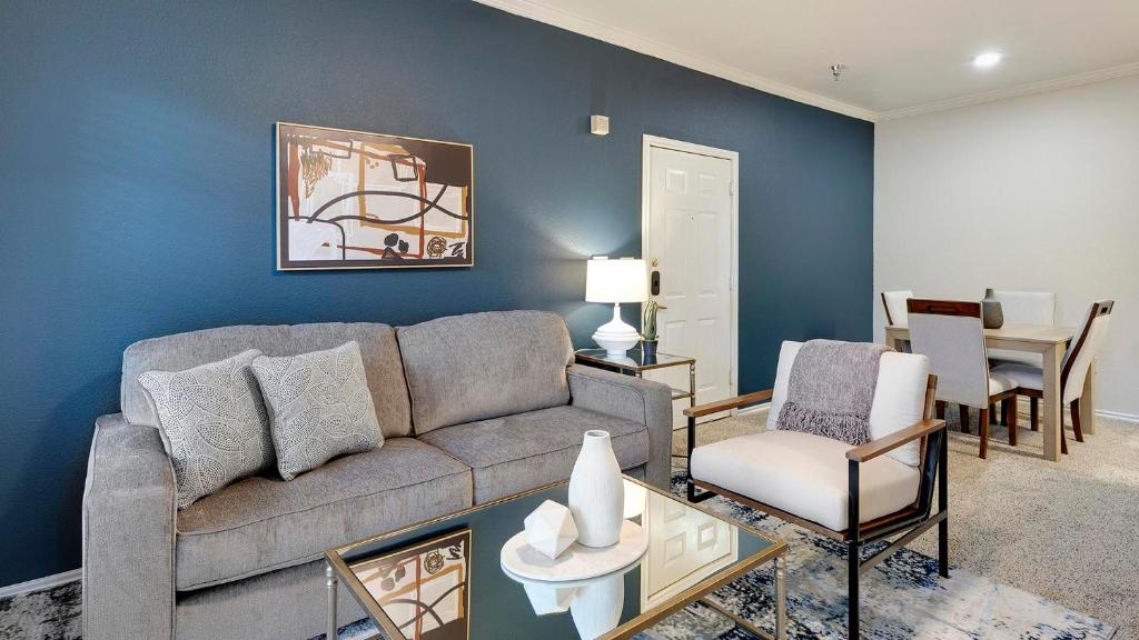 a living room with a couch and a table at Landing Beautiful 1BD Gym in Lewisville