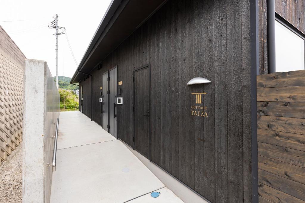 a row of doors on the side of a building at Cottage TAIZA in Kyotango