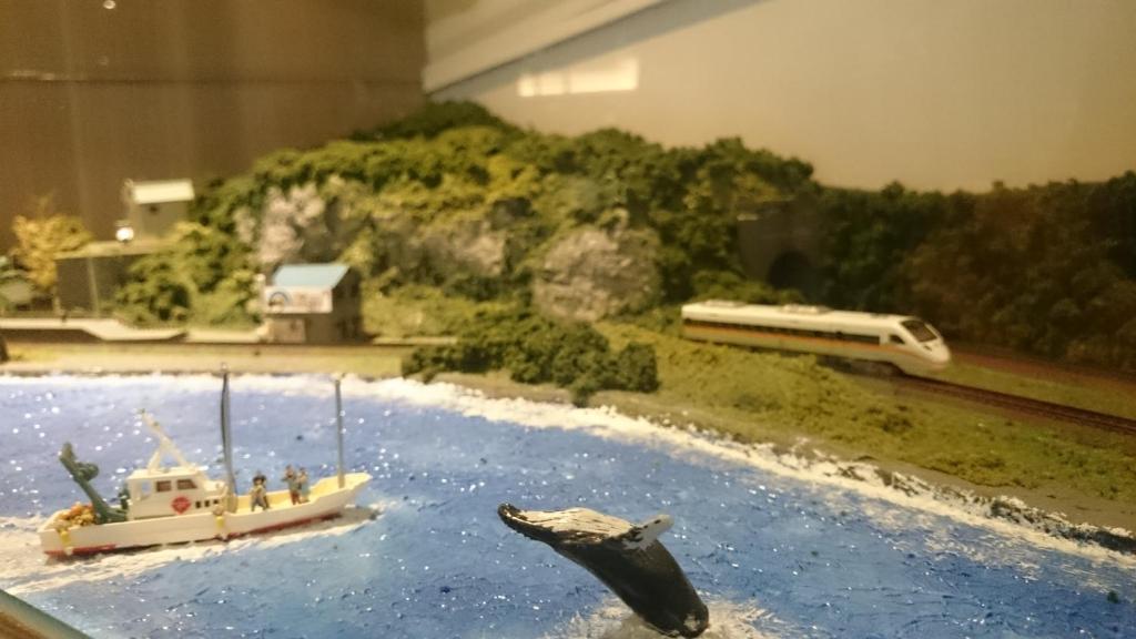 a model of a dolphin and a boat in the water at Grace Hotel in Zhonghe
