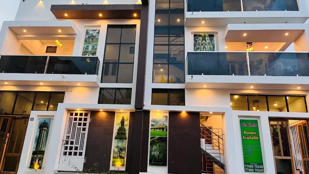 a facade of a building with many windows at THE CHALET- Pondicherry, Near Eden Beach - BMC in Pondicherry