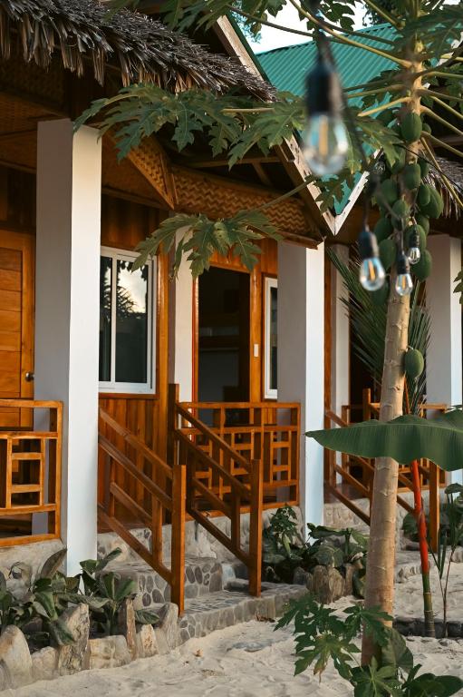 a house on the beach with a porch at Seaside Beach Hostel in San Vicente