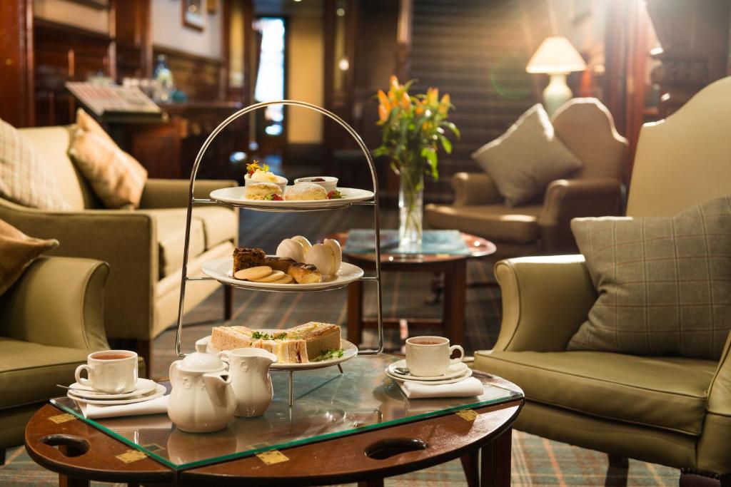 a tray of food on a table in a living room at Leonardo Boutique Huntingtower Perth in Perth