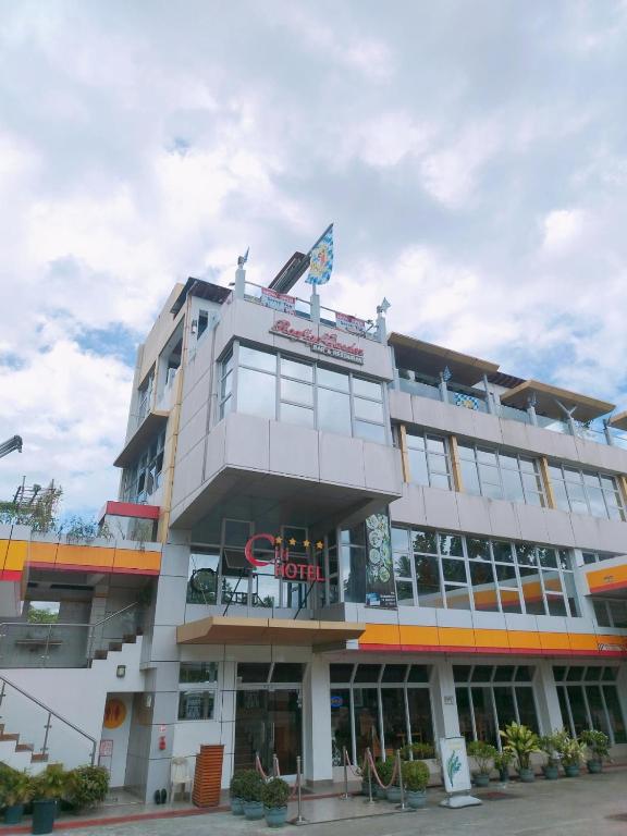 a white building with a sign on top of it at CITI HOTEL in Hilongos