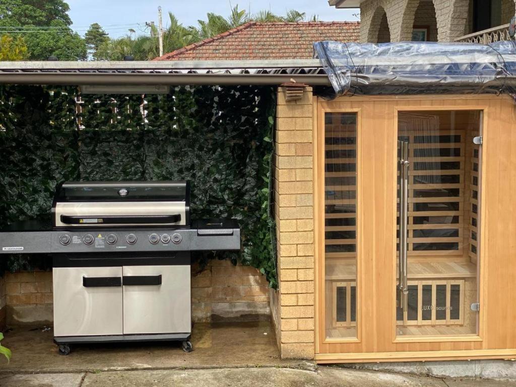 a barbecue grill in front of a house at Executive family house w/ 5BR in Belmont
