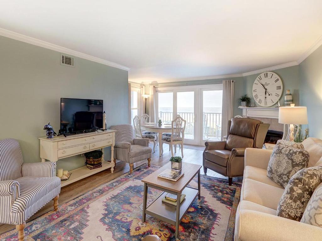 a living room with a couch and a tv at Stay-A-While in Tybee Island