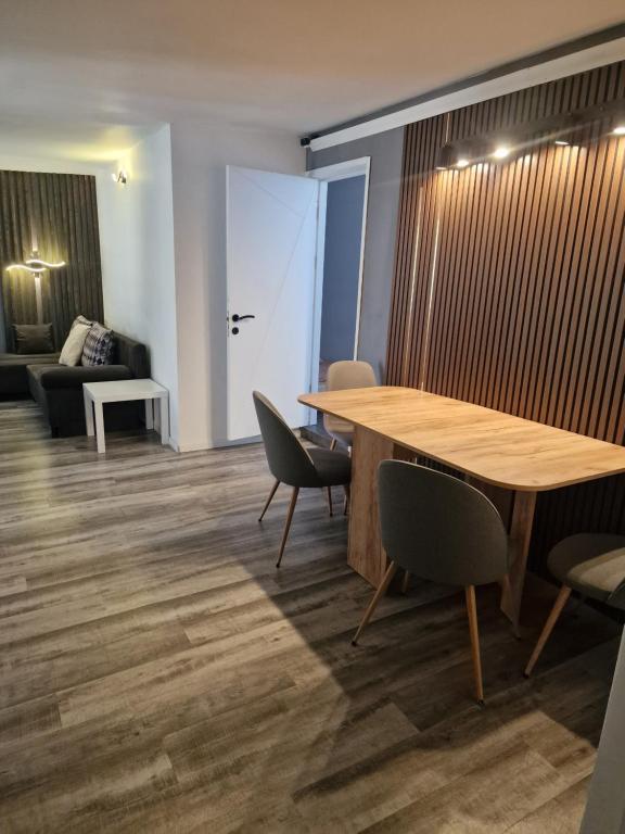 a room with a table and chairs and a couch at Gaia Villa Predeal in Predeal