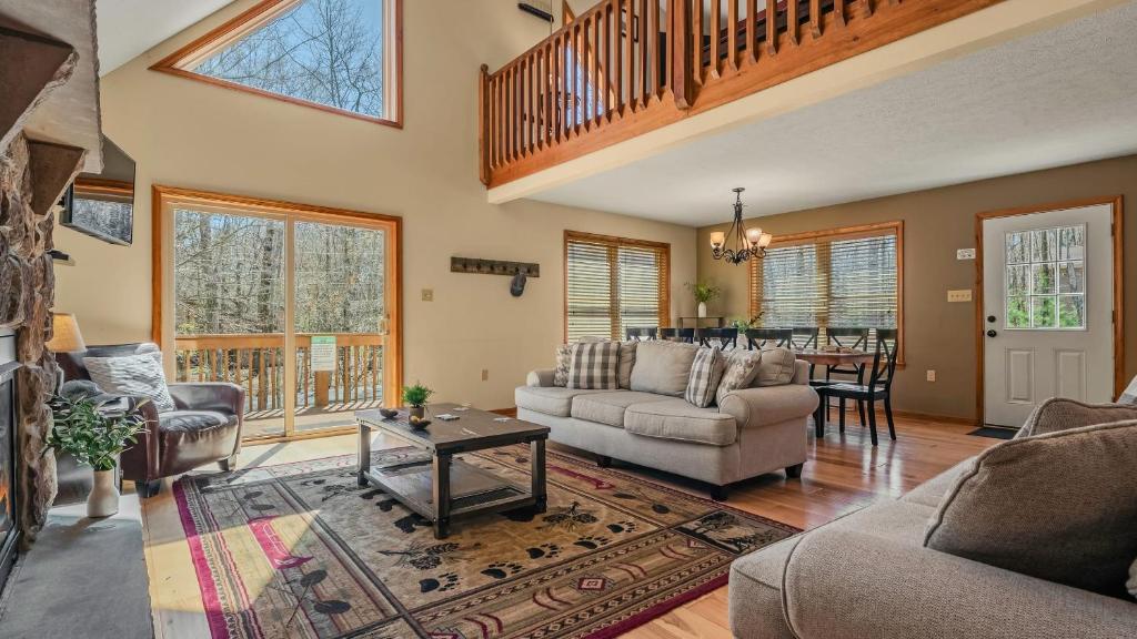 a living room with a couch and a table at Hickory Haven by AvantStay Hot Tub Game Room Theater Deck in Albrightsville