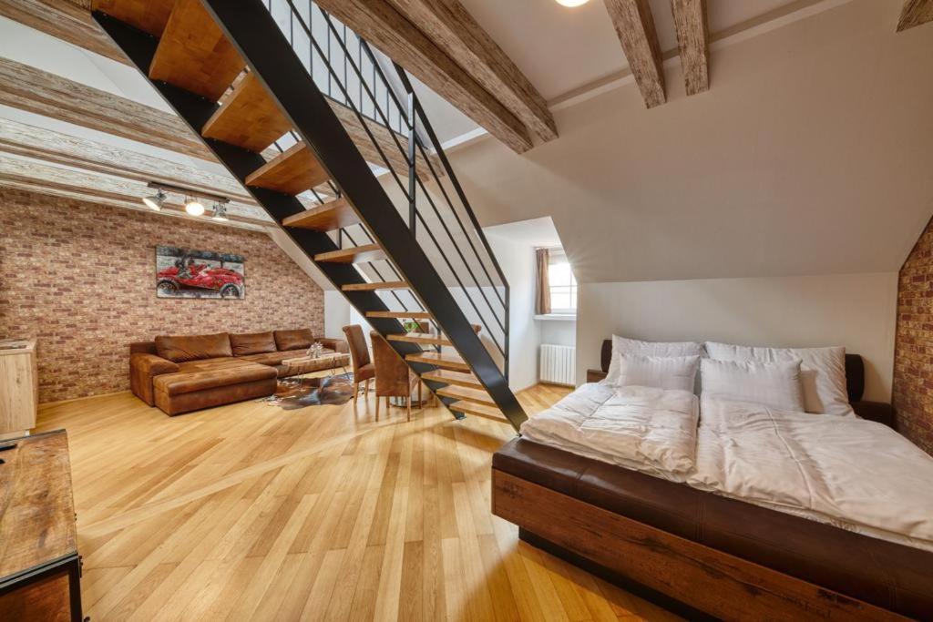 a large bedroom with a bed and a staircase at Ultimate Group Getaway - Three of Everything! in Bratislava