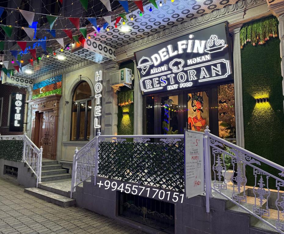 a building with a sign for a sushi restaurant at Delfin Hotel Ganja Restaurant Spa in Ganja