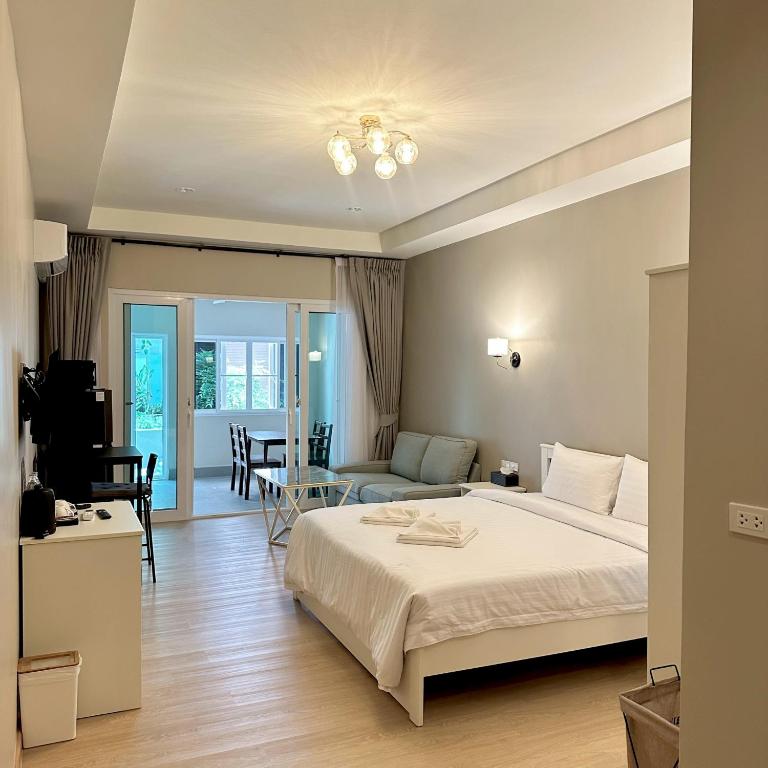 a bedroom with a bed and a living room at J STAR in Jomtien Beach