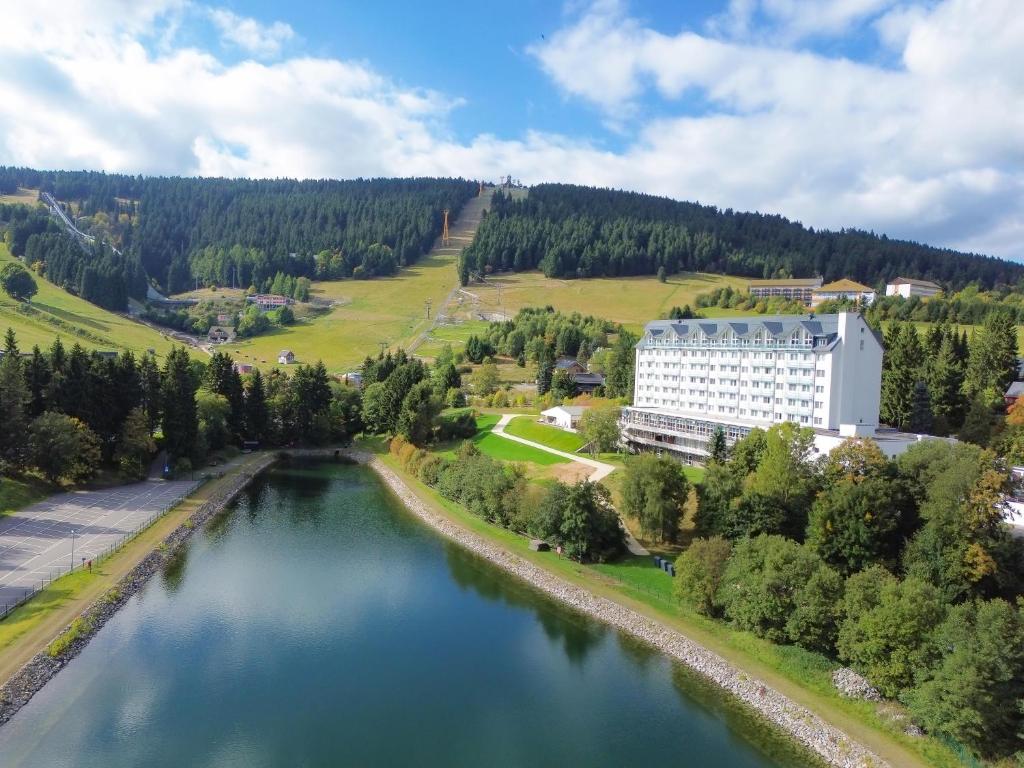 an aerial view of a building next to a river at Best Western Ahorn Hotel Oberwiesenthal – Adults Only in Kurort Oberwiesenthal