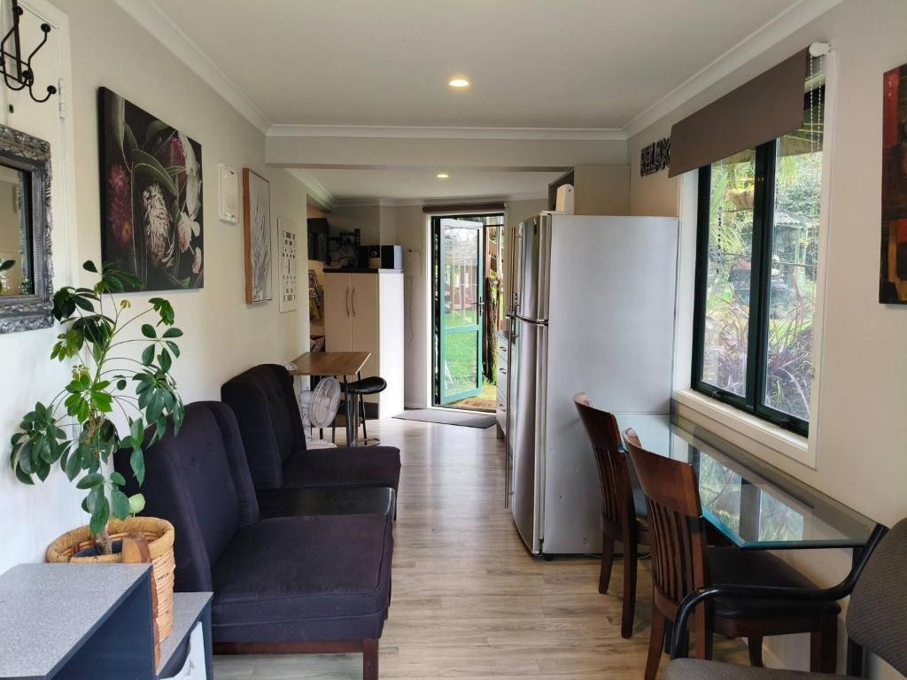 a living room with a couch and a refrigerator at Natures Hideout Private home Luxury in Mourea