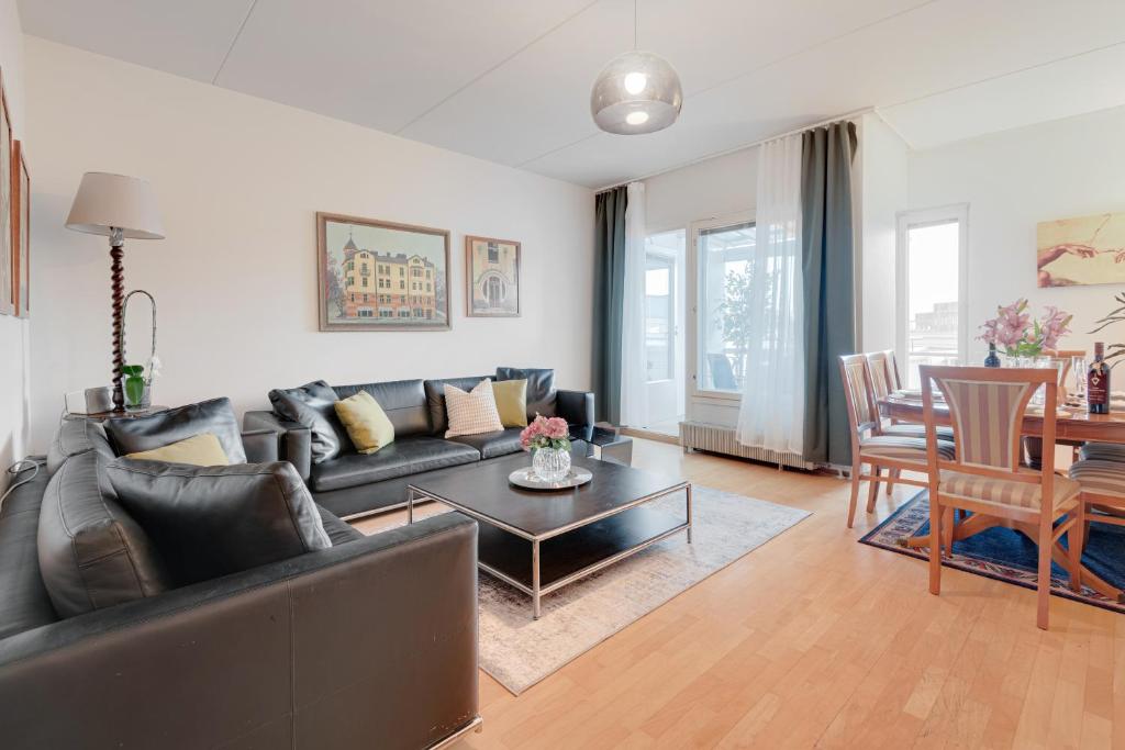 a living room with a couch and a table at Central Luxury Stay w Vintage Charm & Sauna in Helsinki