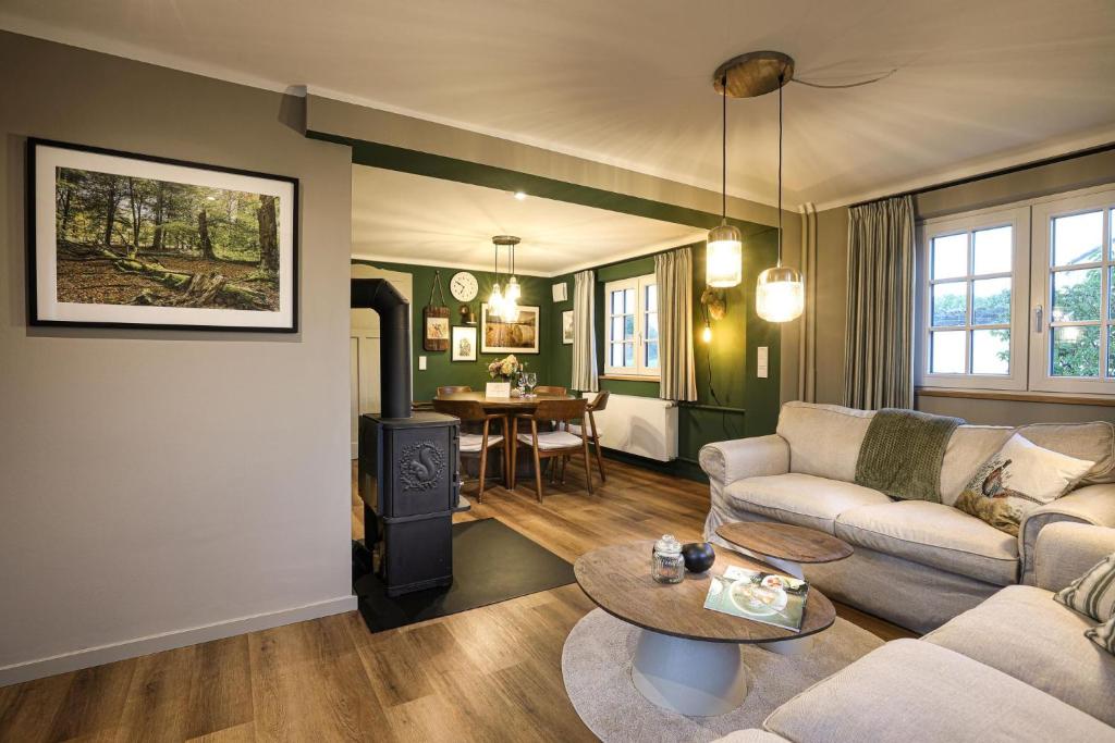 a living room with a couch and a table at Haus Fasanenwiese 