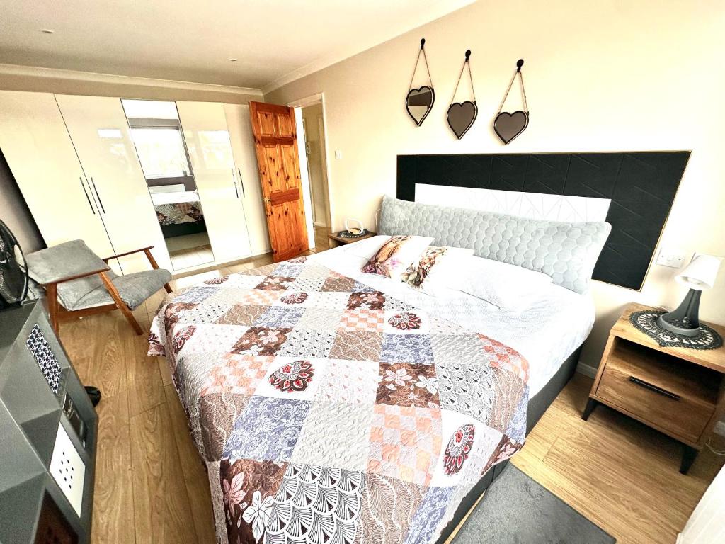 a bedroom with a bed with a quilt on it at Heart of Windsor in Windsor
