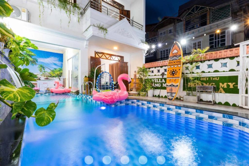 a pool with pink inflatables in a building at Villas Hồ Bơi HM Bãi Sau Thoáng Mát Sân BBQ in Vung Tau