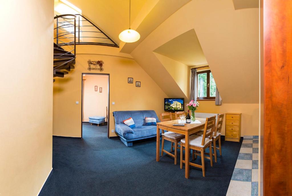 salon ze stołem i kanapą w obiekcie Yellow Ski Apartments w Rokitnicach nad Izerą