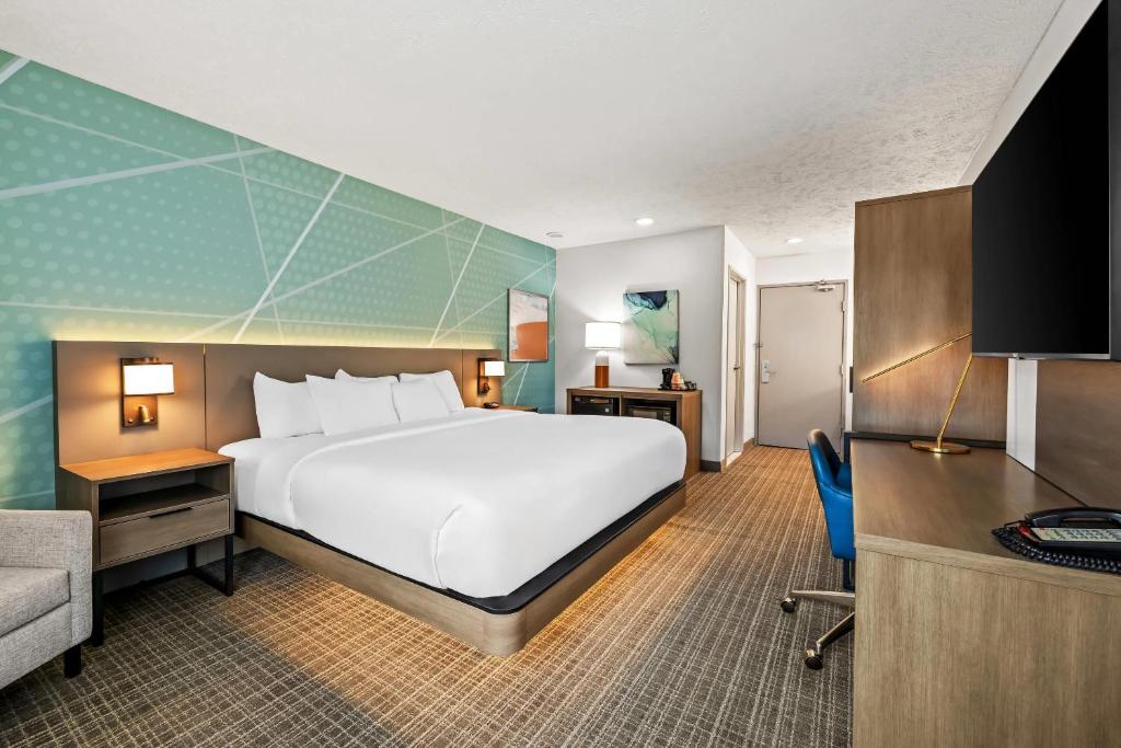 a hotel room with a large bed and a desk at Comfort Inn Traverse City in Traverse City