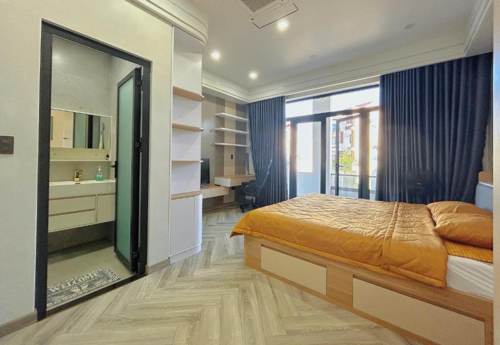 a bedroom with a bed and a large mirror at PAN House - Homestay Villa in Phan Thiet in Ấp Bình Hưng