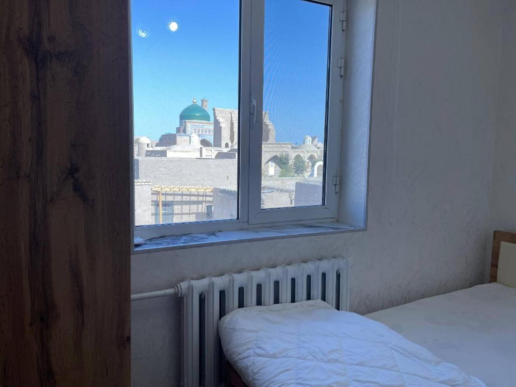 Ένα ή περισσότερα κρεβάτια σε δωμάτιο στο Fayz Guest House