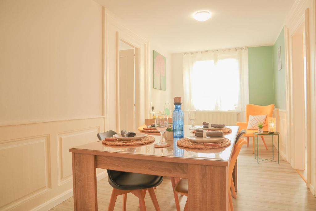 a dining room with a table with chairs and a tableablish at La Bohème - Idéal familles, hyper centre in Mulhouse