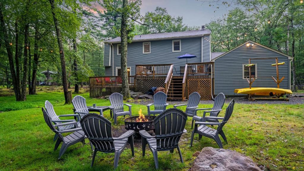 a group of chairs and a table in front of a house at Double Diamond Lodge by AvantStay Group Escape w Firepit Patio Activities in Lake Harmony