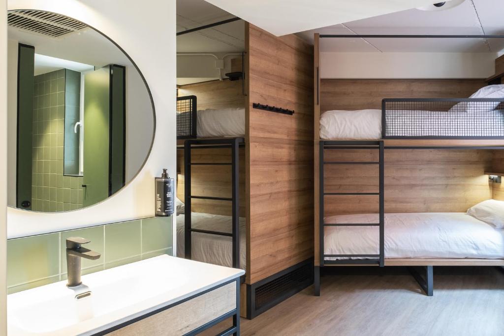 a bathroom with bunk beds and a mirror at LATROUPE Grand Place Hostel in Brussels