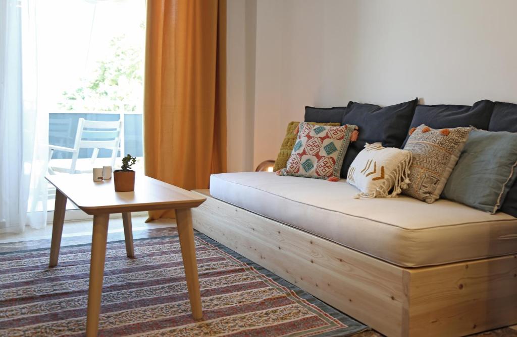 a living room with a couch and a table at Down Town Sitia i in Sitia