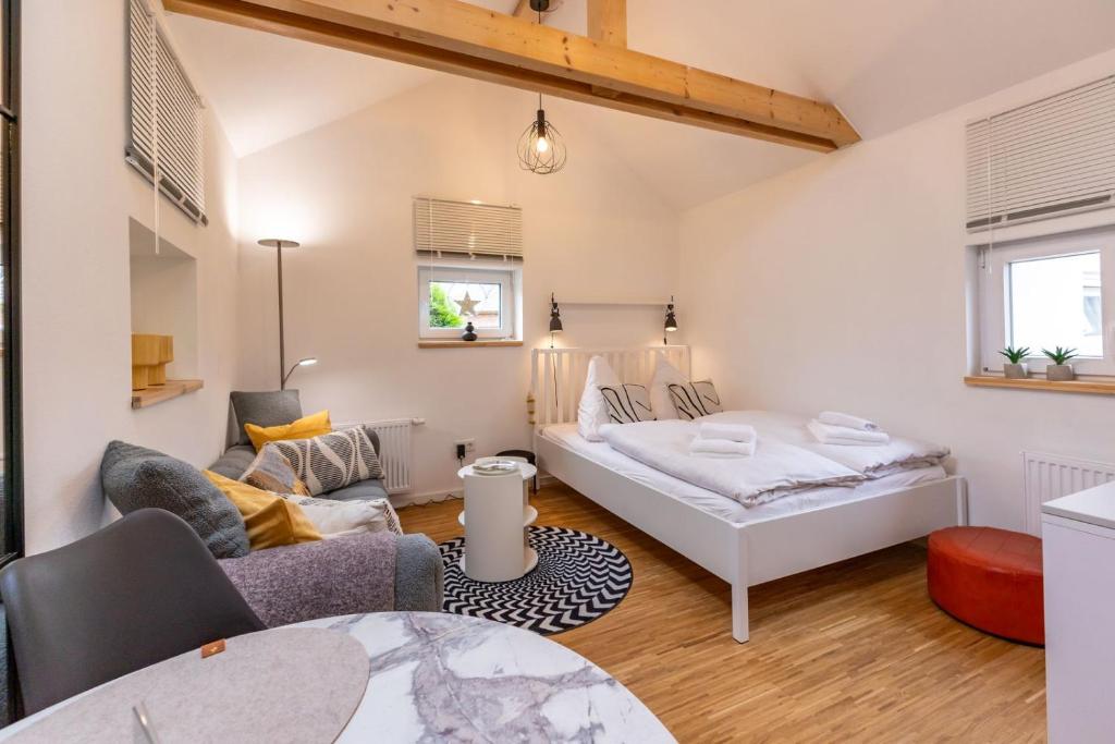 a bedroom with a bed and a living room at Nordseenest in Krummhörn