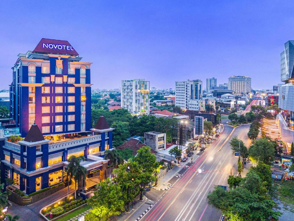a cityscape of a city with a building at Novotel Semarang in Semarang