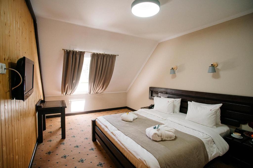 a hotel room with a bed with towels on it at RUBEL APARTHOTEL&SPA in Yaremche