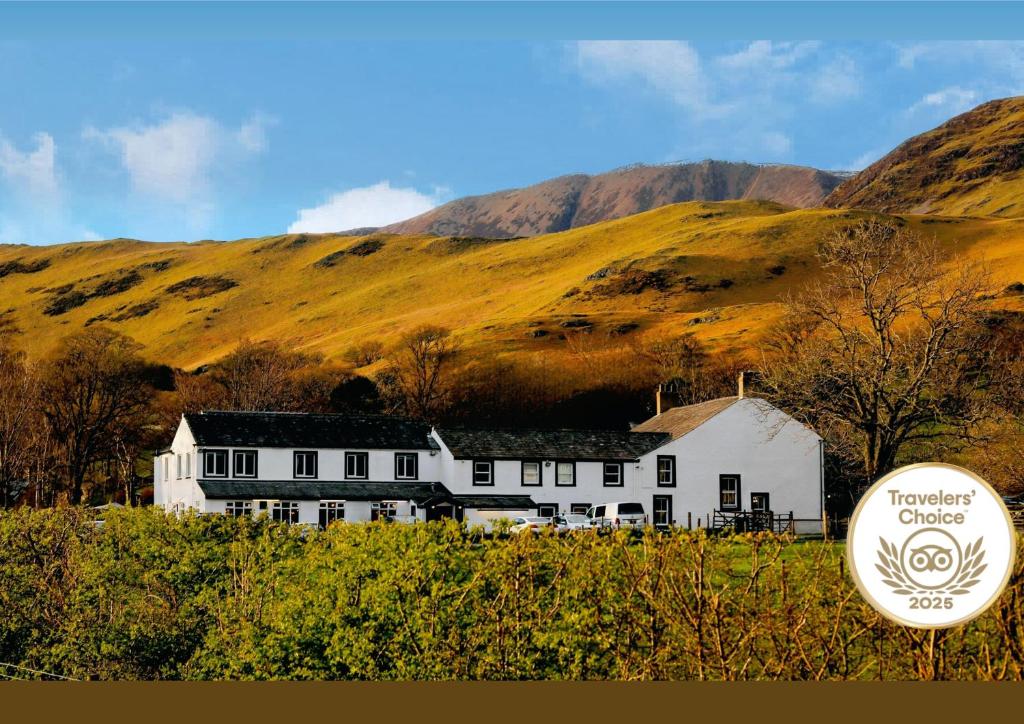 a large white building with a sign in front of it at Buttermere Court Hotel in Buttermere