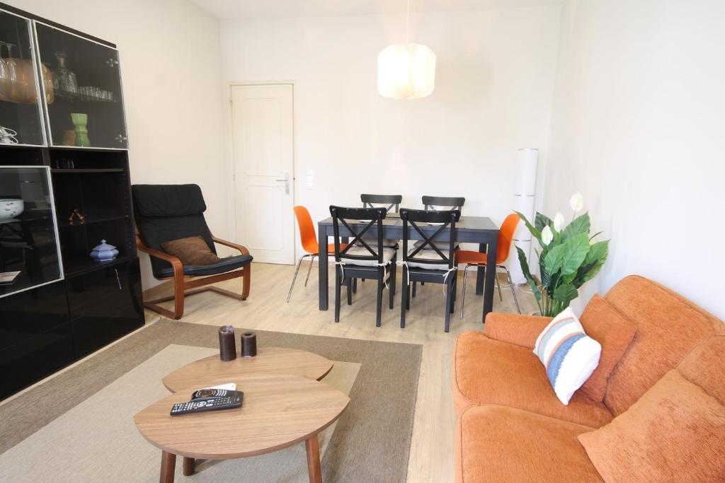 a living room with a couch and a table and chairs at Quinta das Conchas Apartment by Trip2Portugal in Lisbon