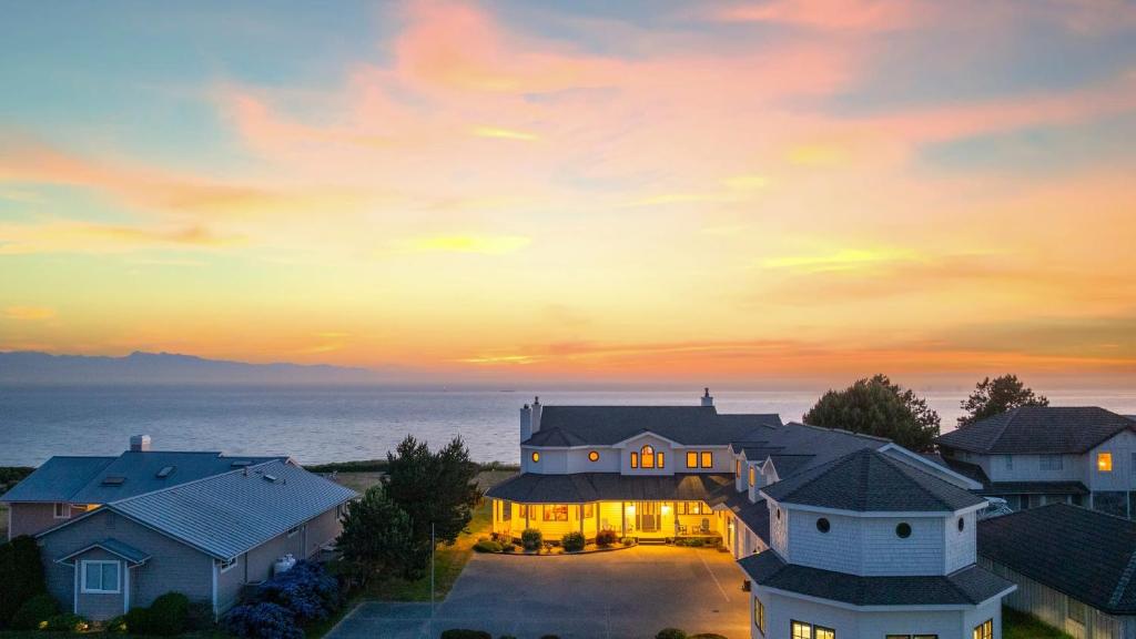 an aerial view of a house with a sunset at Seacliff Haven Waterfront Luxury Stunning Views Hot Tub Game Room in Coupeville