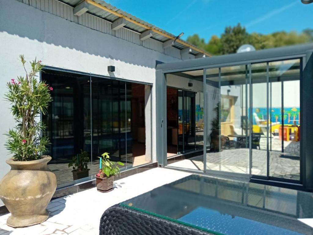 a house with glass doors and a swimming pool at Gyps Vikendica with Swimming Pool and Sauna 2 in Tuzla