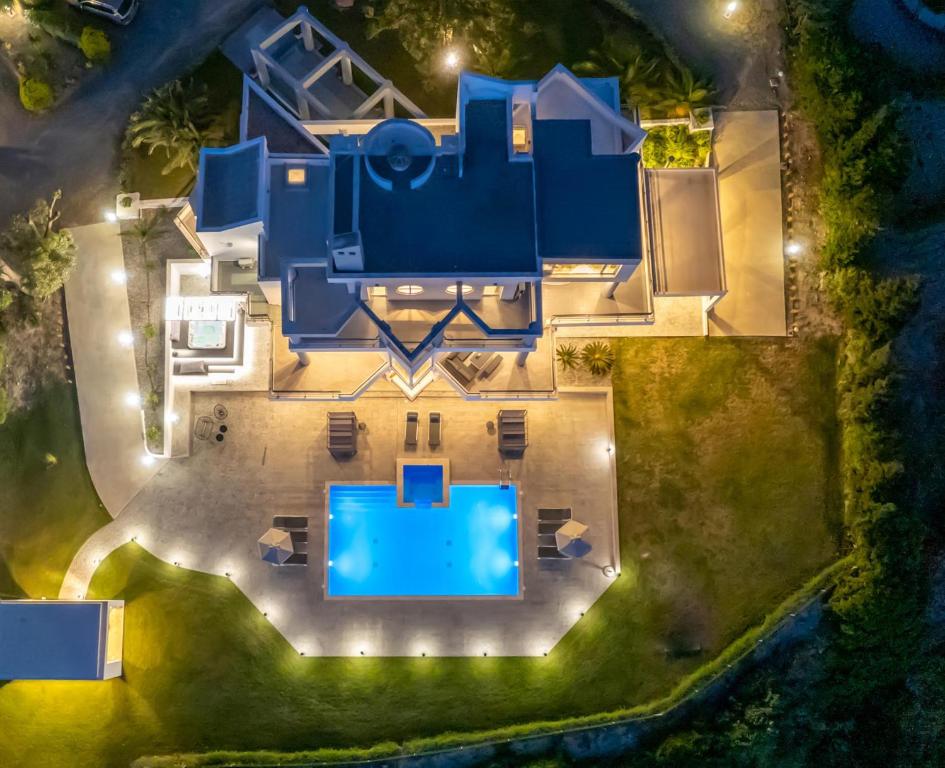 an aerial view of a blue house with a pool at Monte Smith Luxury Villas in Rhodes Town