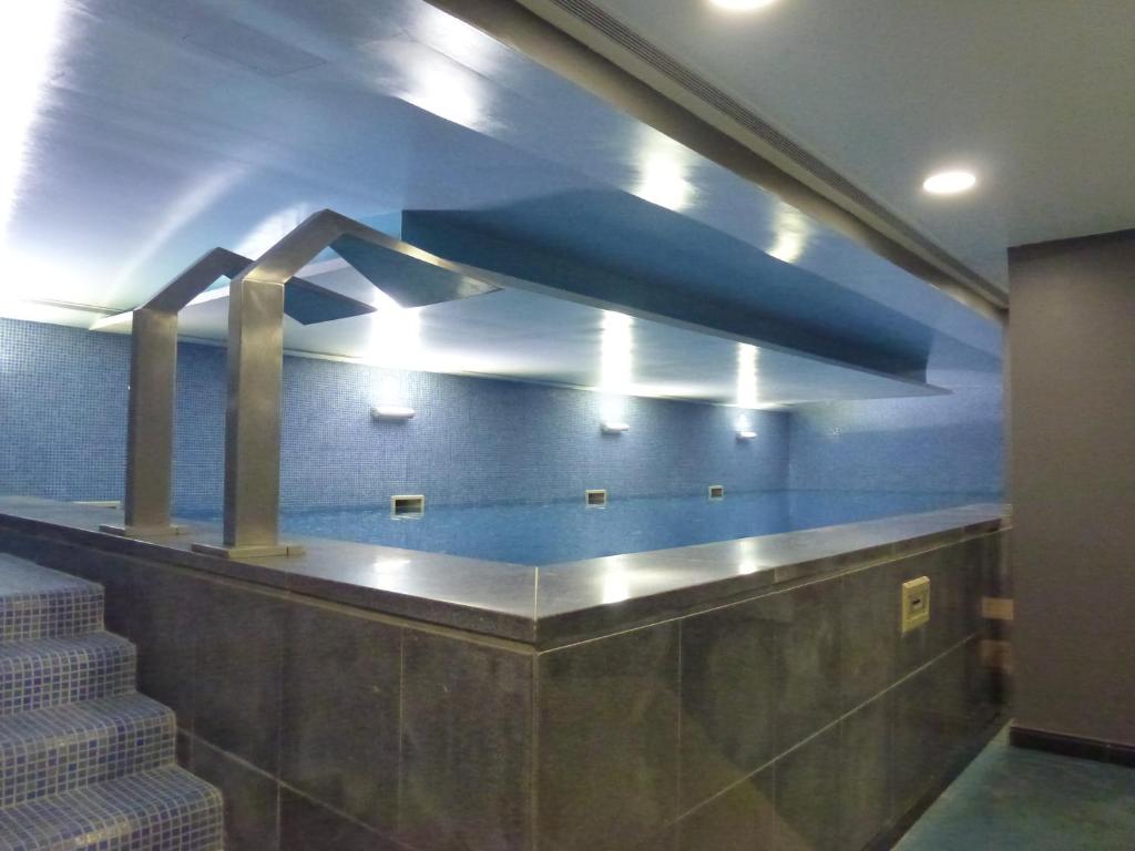 a lobby with stairs and a blue wall at Riviera Hotel in Carcavelos